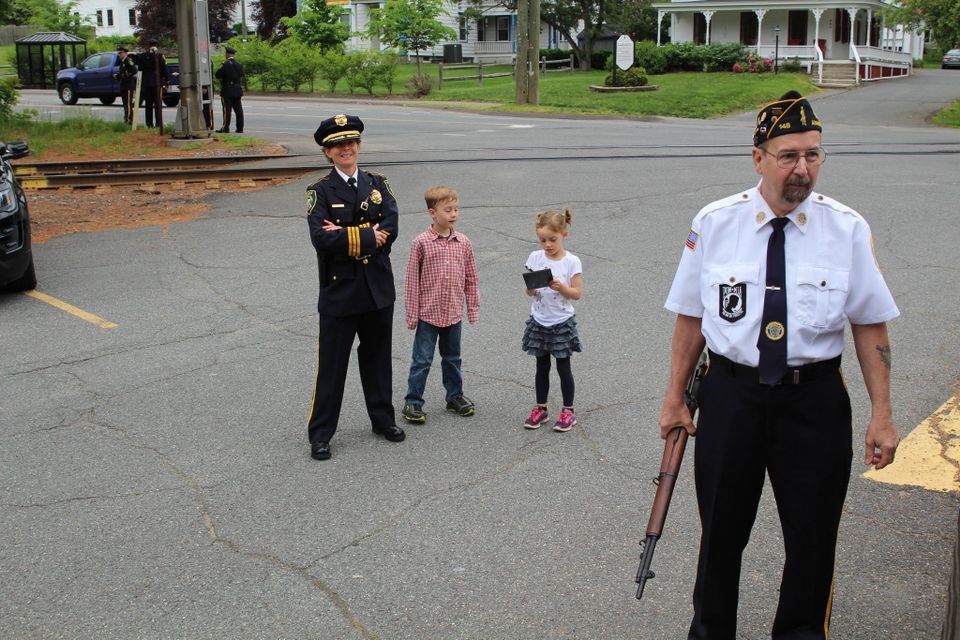 Amherst police Capt. Jennifer Gundersen and her two children, Noah, 7, and Hannah 5 1/2 outside the Amherst VFW, while American Legion Post 148 member stands to the right.